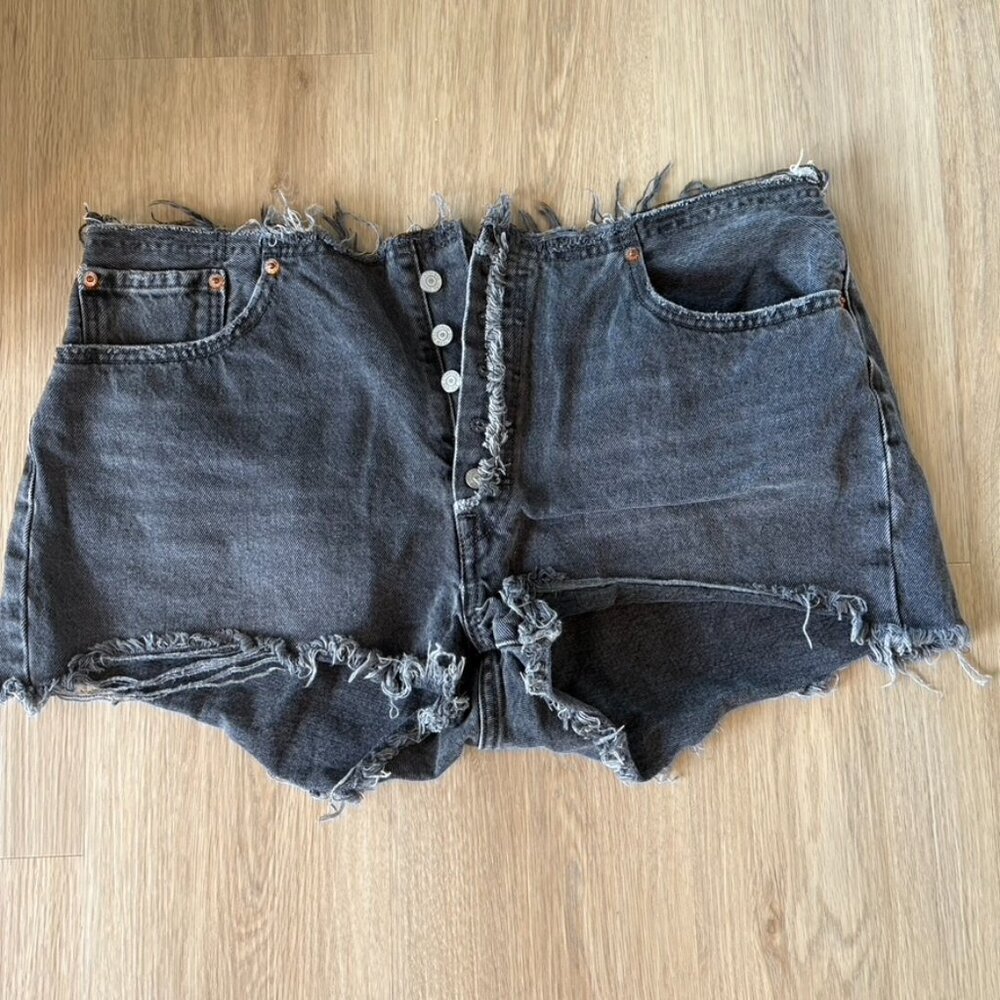 Levi’s high rise faded black raw hem button fly shorts 34"